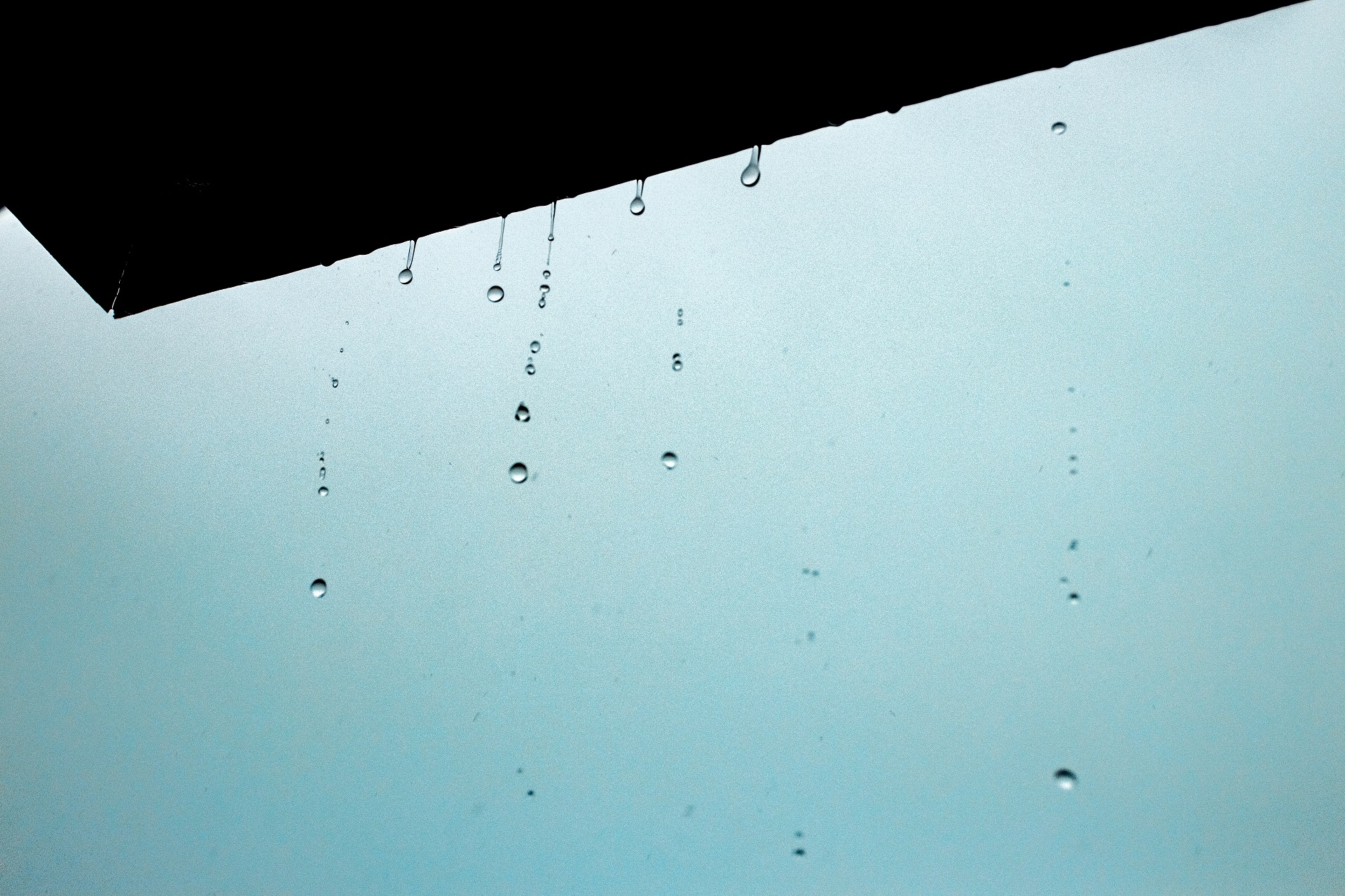A closeup of water drops from the ceiling