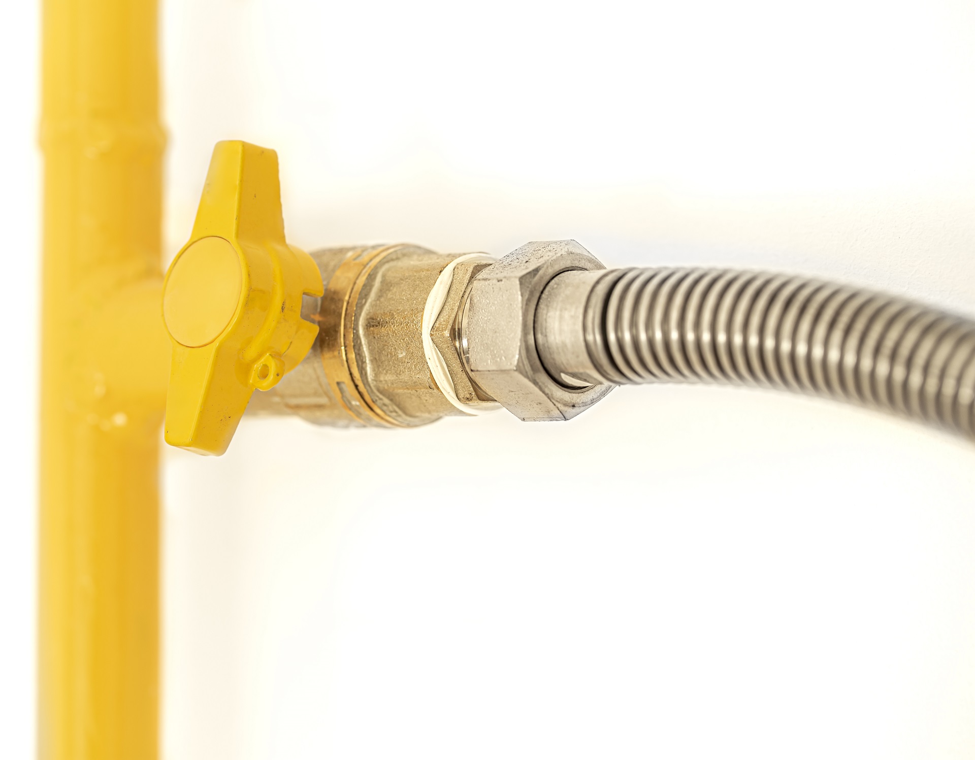Yellow gas pipe with a valve.