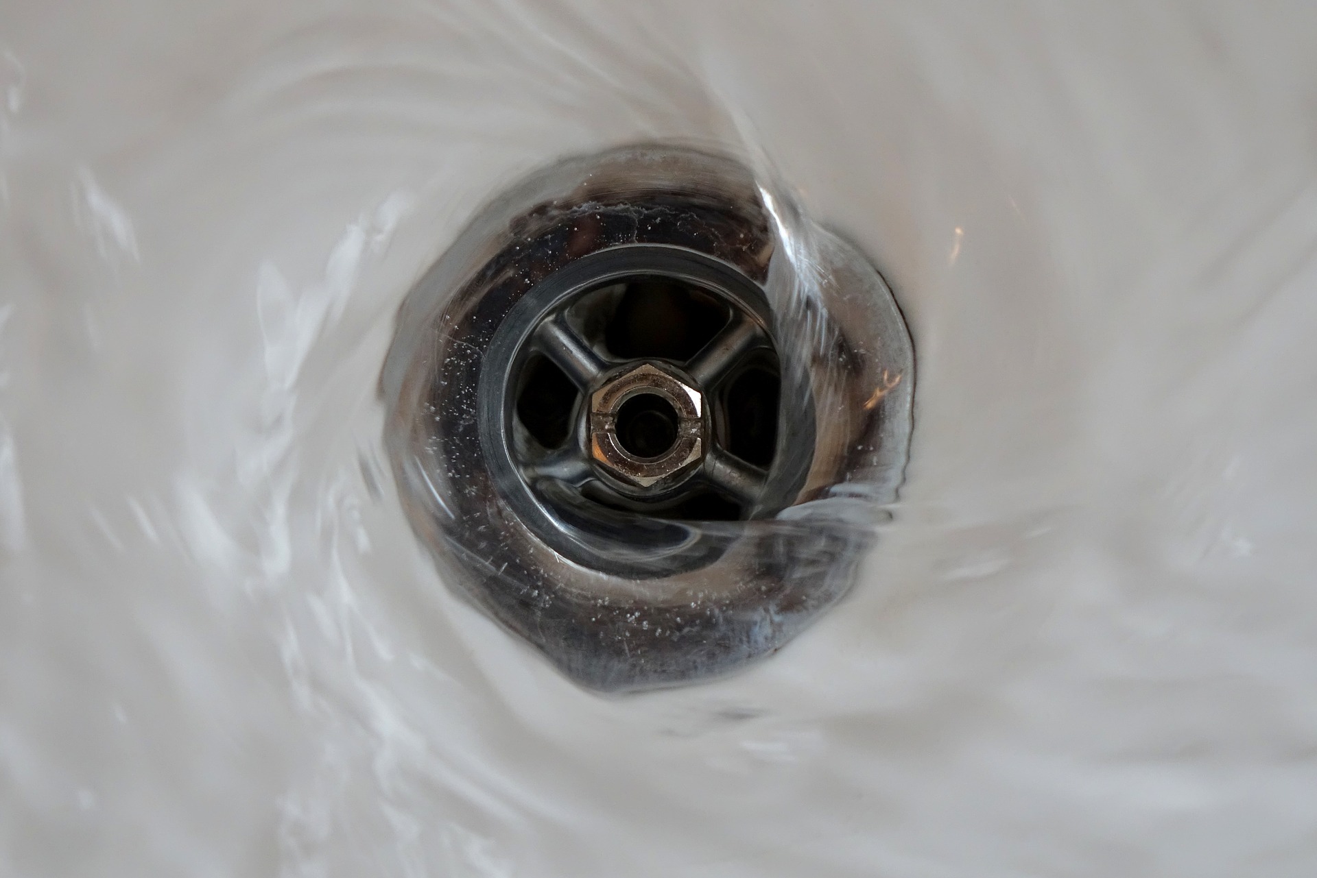 Water going down the drain of a bathroom sink