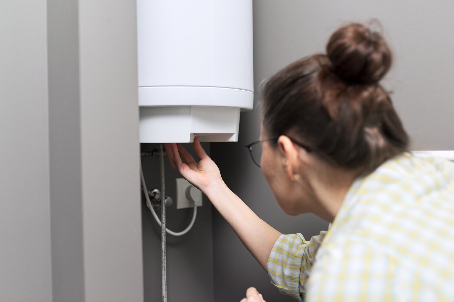 woman checking water heater