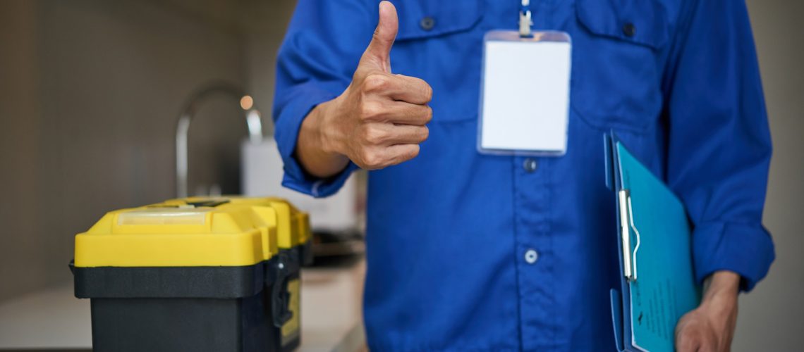 Residential plumber with tool box showing thumbs-up
