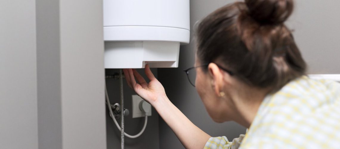 woman checking water heater